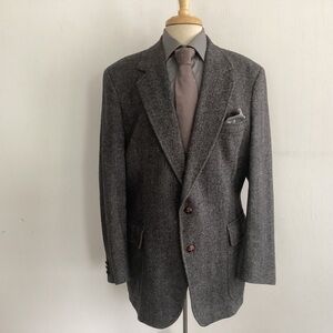 Grey Wool Herringbone 2 button sports jacket with woven leather buttons.…
